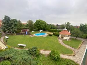 an aerial view of a backyard with a pool and a gazebo at Global Apartmanház in Vonyarcvashegy