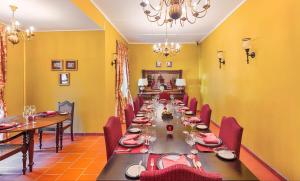 a long dining room with a long table and chairs at Mandira Strathdon by HPL in Watawala