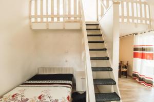 a room with a bunk bed and a staircase at Domek Jabluszko in Wilkasy