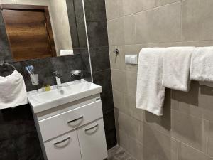 a bathroom with a white sink and a mirror at Kechi in Tsaghkadzor