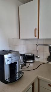 a kitchen counter with a microwave and a coffee maker at Schöne 2-Zimmer Ferienwohnung in Löffingen +4 photos