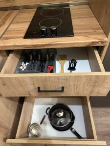 a wooden cabinet with a stove and a frying pan in it at Kechi in Tsaghkadzor