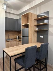 a kitchen with a wooden table and chairs at Kechi in Tsaghkadzor