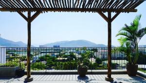 a balcony with a view of a city at Laholm Hotel - Apartment in Nha Trang