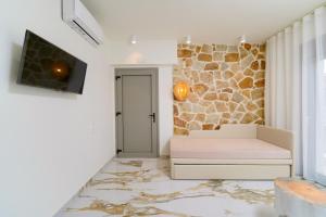 un soggiorno con divano e TV di Athina Palace Luxurious Appartments a Potos