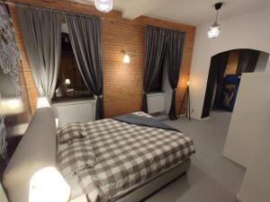 Postel nebo postele na pokoji v ubytování Arcade Apartament