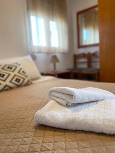 a pile of towels sitting on a bed at La casa de campo in Heraklio