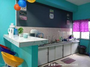 a kitchen with a sink and a counter top at Awani homestay in Semporna