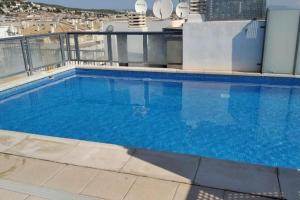 a large swimming pool on the roof of a building at Peñiscola centro capri in Peniscola