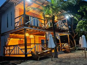 a house on the beach at night with umbrellas at Mio Mio Beach in Barú