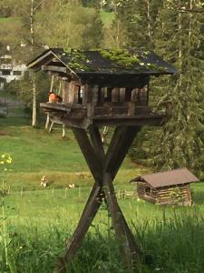 a bird house on a stand in a field at Hof Hintererb in Kitzbühel
