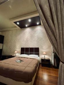 a bedroom with a large bed and two lamps at Bay View in Faliraki