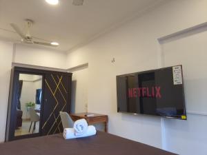 a hotel room with a netflix sign on the wall at OSI Apartments Perry Cross Bandra West in Mumbai