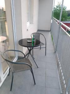 a balcony with a table and two chairs on it at Apartament Jagielloński in Wschowa