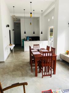 una sala da pranzo e una cucina con tavolo e sedie di Everdew Kandy a Kandy