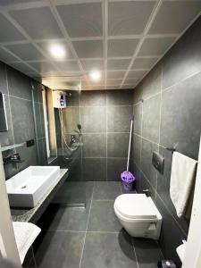 a bathroom with a toilet and a sink at Flamingo Residence in Antalya