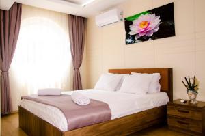 a bedroom with a bed with white sheets and a window at Flamingo Residence in Antalya +34 photos