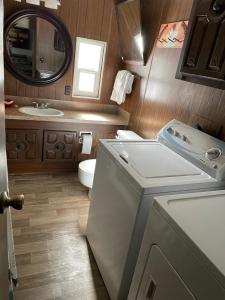 ein Badezimmer mit einer Waschmaschine und einem Waschbecken in der Unterkunft Grandma's Home in the Woods. Yellowstone in Island Park