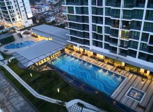 an overhead view of a large building with a swimming pool at Jeff & Ricky Homestay 82@Vivacity Megamall in Kuching