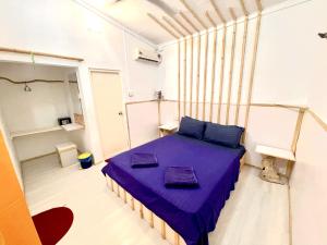 um quarto com uma cama roxa num quarto em Thulusdhoo Garden Villa em Thulusdhoo