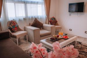 a living room with two chairs and a coffee table at Swiss Royal DAHAB in Dahab