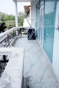 a balcony of a house with a glass door at Divine India Service Apartment 2Bhk, 2A Saket in New Delhi