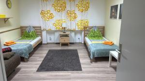 a room with two beds and a couch at Budget studio near Prater in Vienna