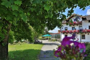 a house with flowers in front of it at Landgasthof Zum Sägwirt in Eggstätt