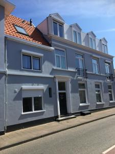 a blue building on the side of a street at Penthouse DeLuxe in Oostkapelle