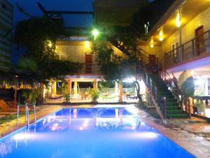 a swimming pool in the middle of a building at night at Phong Nha Dawn Home in Phong Nha