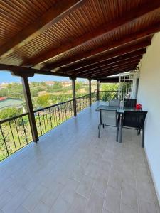 a patio with a table on a balcony at Carefree Dreams : Cottage in Flogita Chalkidiki in Flogita