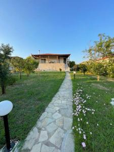 a stone path in front of a house at Carefree Dreams : Cottage in Flogita Chalkidiki in Flogita