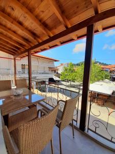 a patio with a table and chairs on a balcony at AGORA LUXURY LOFT in Agios Nikolaos