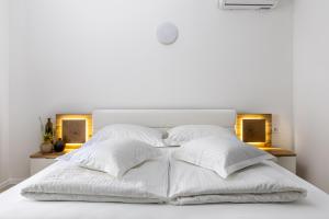 a white bed with white sheets and pillows at Luxury Apartments Klara in Split