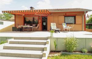 a house with a deck and a patio at 2 Bedroom Amazing Home In Flammersfeld in Flammersfeld