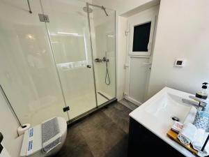 a bathroom with a shower and a toilet and a sink at Seaview & Jacuzzi summer residence in Mýkonos City