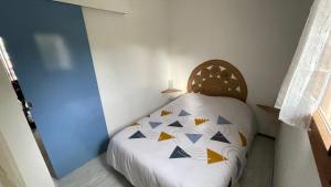 a bedroom with a bed with blue and yellow at « L’hispaniola » avec sa vue sur la marina in Saint-Cyprien