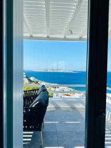a window view of the ocean from a balcony at Seaview & Jacuzzi summer residence in Mýkonos City