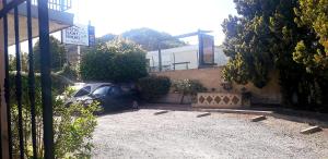 a car parked in a parking lot next to a building at Hôtel Saint Michel in Digne-les-Bains