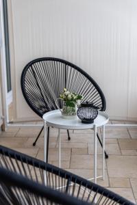 a chair with a vase of flowers on a table at Luxury Apartments Klara in Split