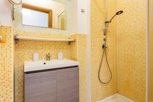 a bathroom with a sink and a shower at Catania Inn Rooms in Catania