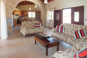 ein Wohnzimmer mit 2 Sofas und einem Tisch in der Unterkunft Lianti in Pomos