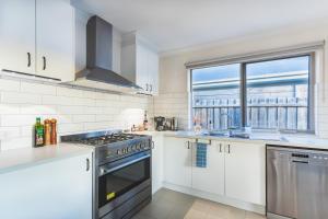 a kitchen with white appliances and a window at La Casa Serenità - peaceful retreat with infrared sauna in Moolap +43 photos