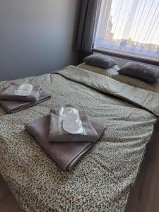 two beds with towels sitting on top of them at Apartament Słowińców 32 in Wejherowo +10 photos