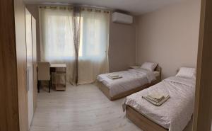 een kleine kamer met 2 bedden en een raam bij Apartment Mladost 2 - Free Parking in Sofia