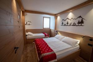 a small room with two beds in it at Residence Ronchi in Molveno