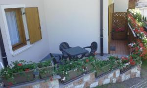 a patio with a table and a bunch of plants at Residence Ronchi in Molveno