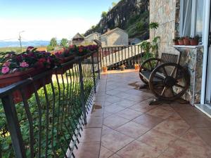 a balcony with flowers on a fence and a bench at Skadar Lake Apartment -Karolina in Vranjina