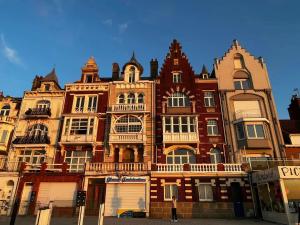 a large building with many windows on a street at La maison du Pêcheur in Grand-Fort-Philippe