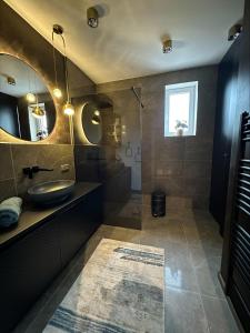 a bathroom with a sink and a shower at Apartmán Maťko in Levice